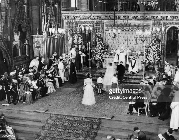 Princess Elizabeth and The Duke Of Edinburgh kneeling in front of the Archbishop of Canterbury during their marriage ceremony in Westminster Abbey.