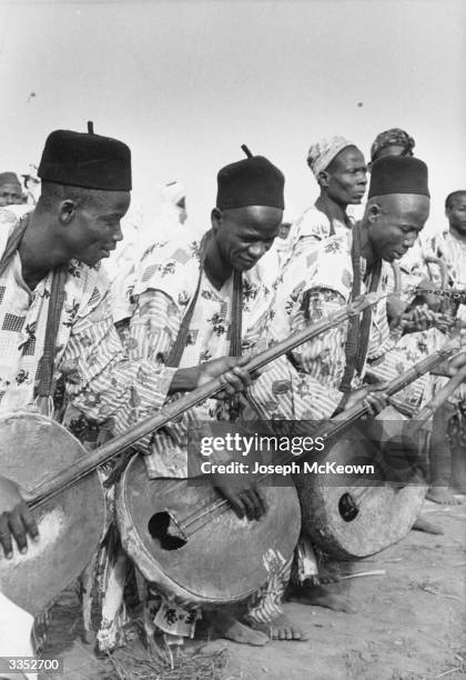 Nigerian musicians playing traditional stringed instruments during the Queen's visit to Nigeria. Original Publication: Picture Post - 8274 - The...