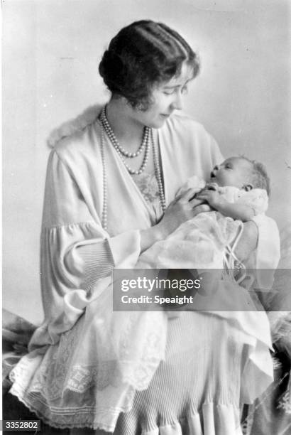 Elizabeth, Duchess of York holding her baby, the future Queen Elizabeth II.