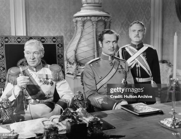 American actor Robert Montgomery sits in front of Frank Morgan in a scene from 'Suicide Club' , directed by J Walter Ruben for MGM.