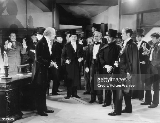 Actors Tom Moore, Reginald Owen , Frank Morgan and Robert Montgomery star in the film 'Suicide Club' , directed by J Walter Ruben for MGM.