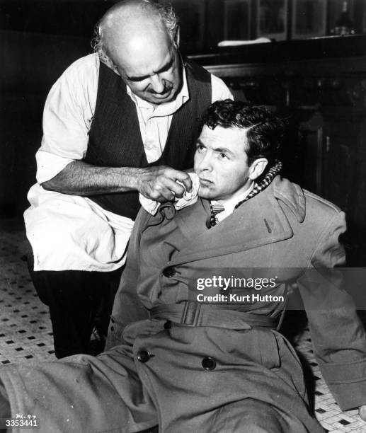 Actor Biff Elliot playing Mickey Spillane's battered detective Mike Hammer in the United Artists film noir 'I, the Jury'. Original Publication:...