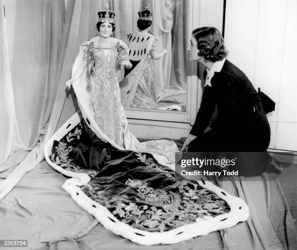 Miniature mannequin of Queen Elizabeth , consort of George VI, in full Coronation regalia made at the Royal School of Needlework, London.