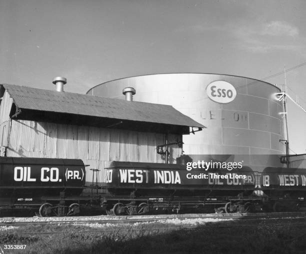 Large Esso gasoline tank and freight tanks full of oil on a railway line at San Juan, Puerto Rico.