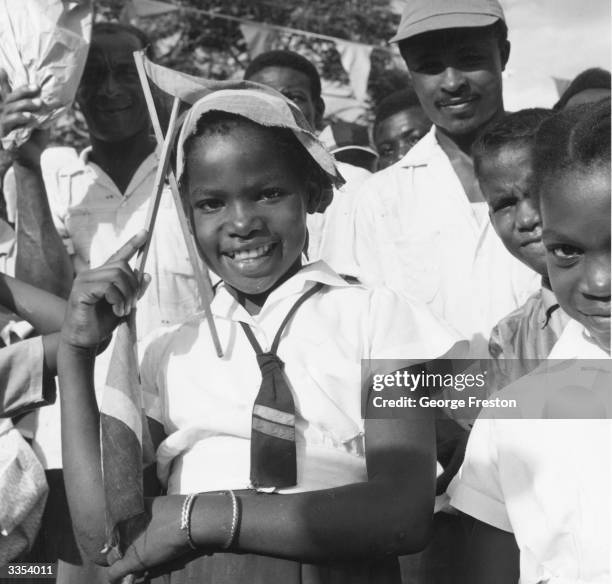 Jamaican schoolgirl in Kingston with the countries new flag during Jamaica's independence celebrations.