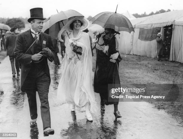 First day fashions at Ascot get caught in the rain.