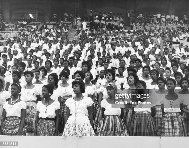 Girls wearing different varieties of Jamaican national dress in a stadium on the island during the country's independence celebrations.