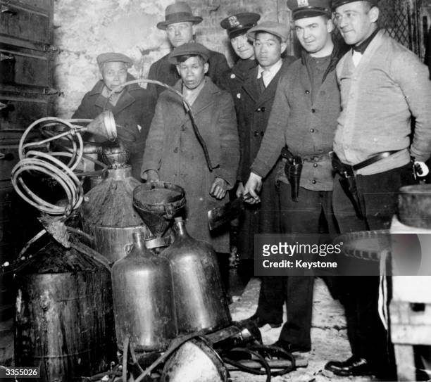 Raid on a basement, in Mulberry Street, New York, where a group of Orientals were suspected of making hooch during Prohibition.