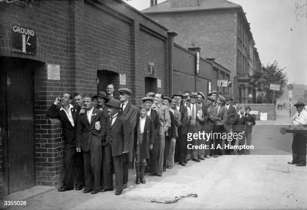 Football fans queue up outside the Arsenal ground at Highbury, London, three hours before kick-off in the Arsenal versus Everton match.