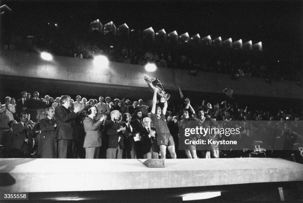 Liverpool captain Phil Thompson holds the European Cup aloft in victory after his side's 1-0 victory over the Spanish team Real Madrid in the...