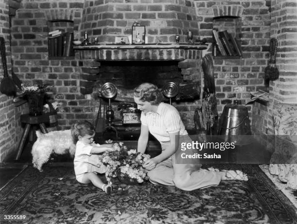 Actress Diana Beaumont in her twelve hundred year old house with her sixteen month old son, David John. She is starring in 'Admirals All' at the...