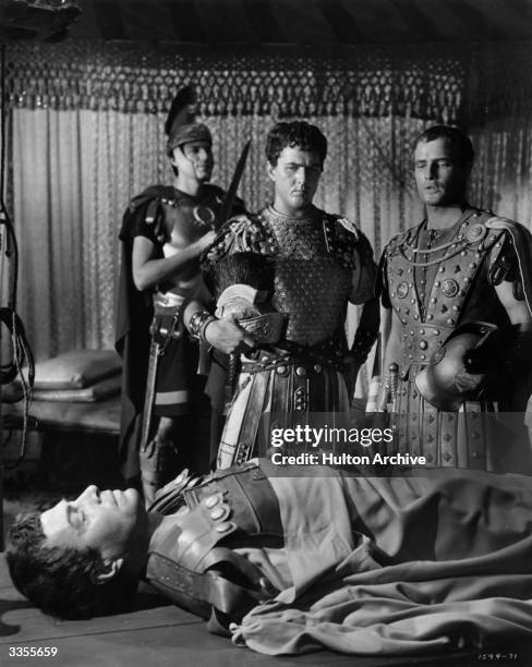 Marlon Brando and Douglass Watson survey the corpse of James Mason , in the part of Brutus, in the MGM film adaptation of 'Julius Caesar'.