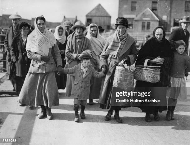 Some of 300 inhabitants of the Outer Hebrides who are to emigrate to Canada arriving at the pier at Lochboisdale, South Uist, to board Canadian...