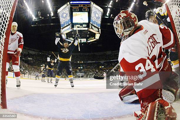 Goalie Manny Legace of the Detroit Red Wings looks back as the puck slides between his legs for a goal by Vladimir Orszagh of the Nashville Predators...