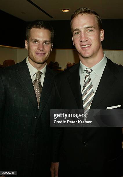 Quarterbacks Tom Brady and Peyton Manning attend the Ermenegildo Zegna Flagship store opening April 13, 2004 in New York City.