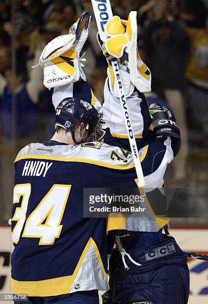 Shane Hnidy hugs goalie Tomas Vokoun of the Nashville Predators as he celebrates a 3-0 win over the Detroit Red Wings during game four of their first...