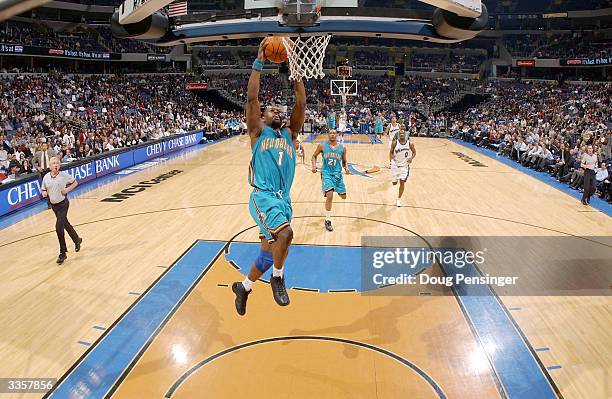 Baron Davis of the New Orleans Hornets goes for a dunk during the game against the Washington Wizards at MCI Center on March 1, 2004 in Washington,...