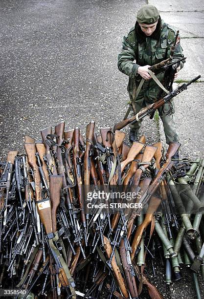 Bosnian Serb Army soldier inspects the rifles before their destruction in Banja Luka, northwestern Bosnia, 14 April 2004. The NATO-led stabilisation...