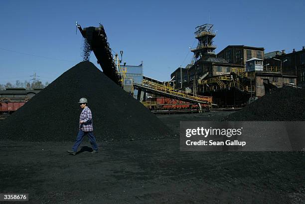 Worker walks past a pile of freshly-mined, high quality coal at the Wieczorek coal mine April 14, 2004 in Katowice, Poland. Poland will be the...