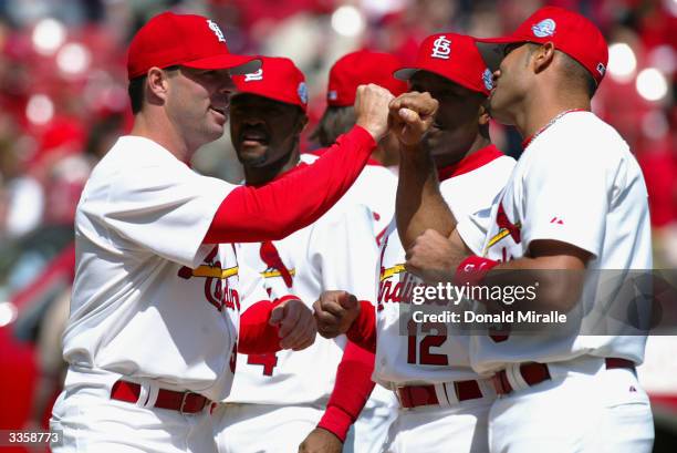 Center fielder Jim Edmonds of the St. Louis Cardinals bashes hands with teammate Albert Pujols before the game against the Milwaukee Brewers on...