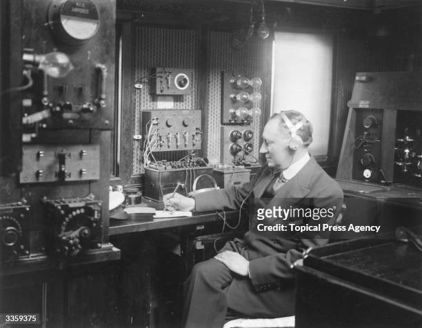 Italian electrical engineer Guglielmo Marconi at work in the wireless room of his yacht Electra.