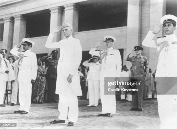 Muhammad Ali Jinnah taking the salute at a military march past in Karachi, having been sworn in as the first Governor General of the Muslim Dominion...