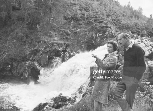 Queen Elizabeth II and Prince Philip, Duke of Edinburgh by a waterfall in the grounds of Balmoral Castle, Scotland. Queen Victoria's husband, Prince...