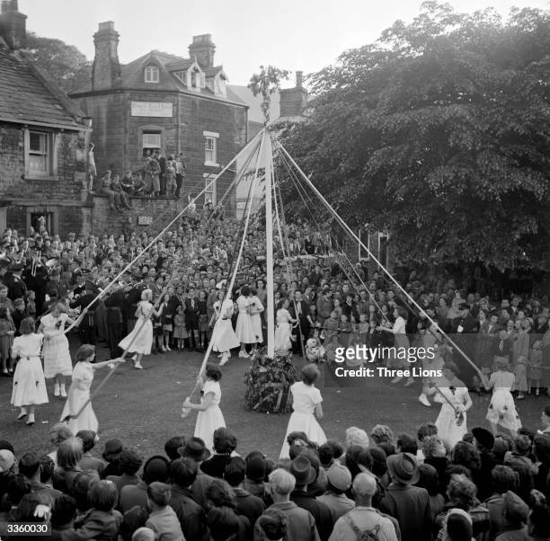 The arrival of Spring is marked in Castleton, Derbyshire, with a festive dance around a maypole decorated with flowers and ribbons.
