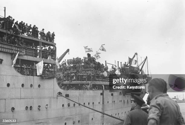 Jewish adults and children, many of whom are survivors from concentration camps, arrive in Haifa on board the French ship SS Champollion to begin new...