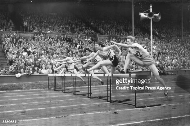 The 100 metre hurdles in the Olympic women's finals at Wembley Stadium. Right to left : Francina 'Fanny' Blankers-Koen 1st, Maureen A G Gardner 2nd,...