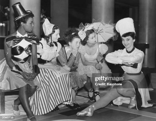 Audrey Hepburn with the cast of a Christmas Party revue at the Cambridge Theatre. The play for children stars Hepburn as a cossack, along side Cherry...