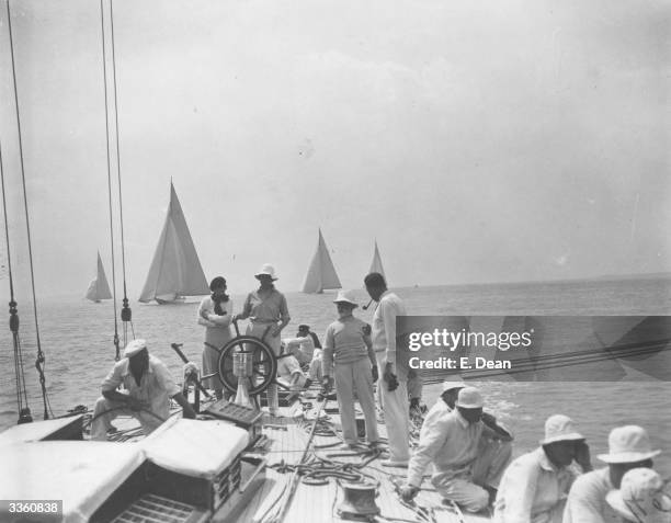 Endeavour, Thomas Sopwith's America's Cup yacht in sail with its crew whilst other yachts sail in the background during the Cowes Regatta, off the...