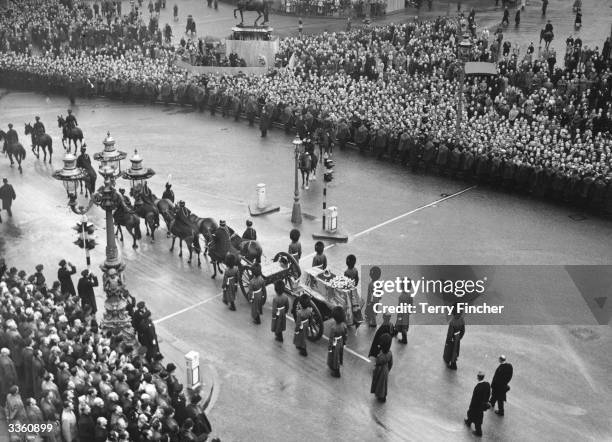 The funeral procession for George VI passing through Trafalgar Square in London on the way to the service at Westminster Hall where the King will lie...