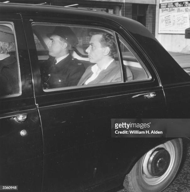 Convicted murderer, Ian Brady under guard in a police car.