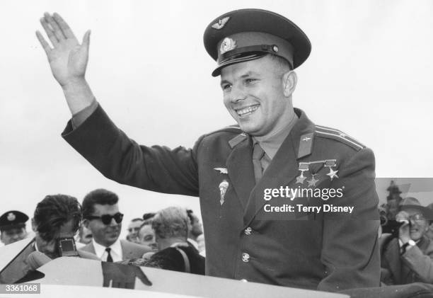 Russian cosmonaut Major Yuri Gagarin, the first human to enter space, waves to crowds who have come to see him at the Soviet exhibition at London's...