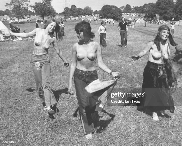 Hippy festival-goers enjoy the sunshine and good vibes at the second Glastonbury Fayre, organised by Arabella Churchill and Andrew Kerr at Worthy...