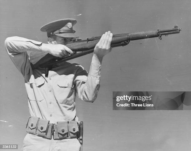 An American soldier aiming a semi-automatic Garand Rifle.