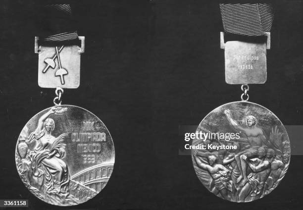 Close up of an Olympic gold medal awarded at the nineteenth games in Mexico 1968, obverse on the left reverse on the right.