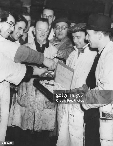 Charlie Hill collecting cigarettes from colleagues at Billingsgate Fish Market,, London, to give to Minesweeper crews.