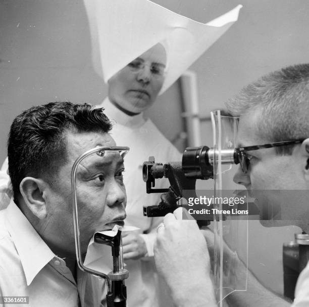 Patient at the US Public Health Service Hospital, Carville, LA having his eyes examined. This hospital for leprosy sufferers is run by nuns.