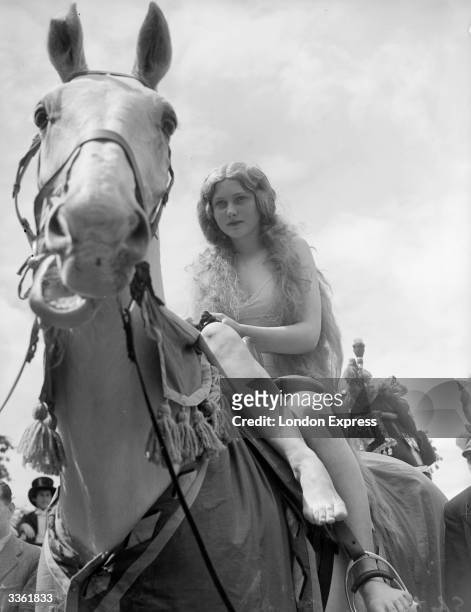 Year-old convent schoolgirl Mirabelle Muller rides through Teddington during the town fete, taking the role of Lady Godiva, an English noblewoman of...
