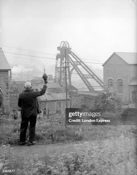 Miner stands near a coal mine.