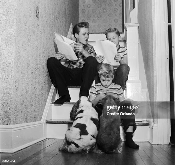 Television stars Ken, Ronnie and Glenn Walken rehearsing their lines on the stairs of their home in Bayside, Long Island.