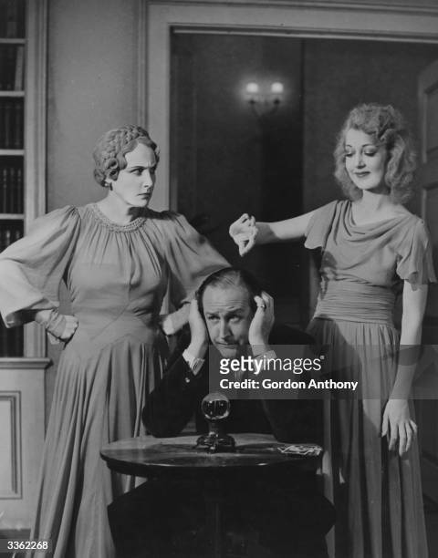 Fay Compton as Ruth, Cecil Parker as Charles and Kay Hammond as Elvira in the Noel Coward play 'Blithe Spirit' at the Piccadilly Theatre, London.