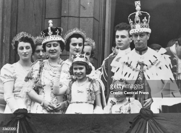 King George and Queen Elizabeth with Princesses Elizabeth and Margaret and members of the extended Royal Family in full Coronation regalia on the...