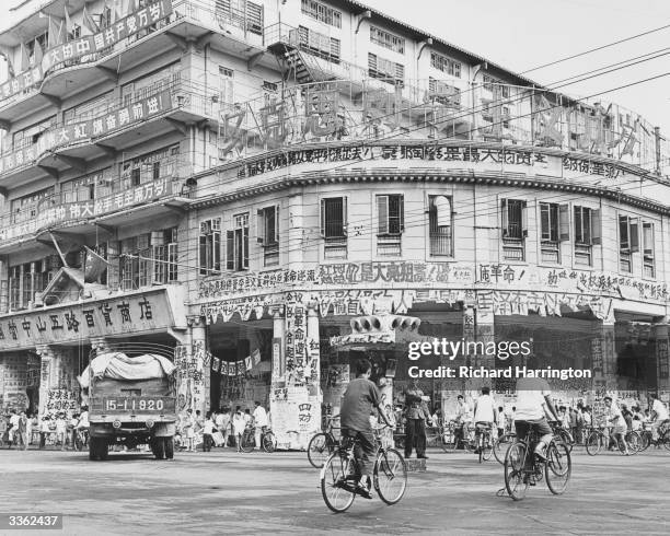 Building covered with dazebao at Canton during the Cultural Revolution. The neon sign reads 'Long Live Marxism and Leninism'.