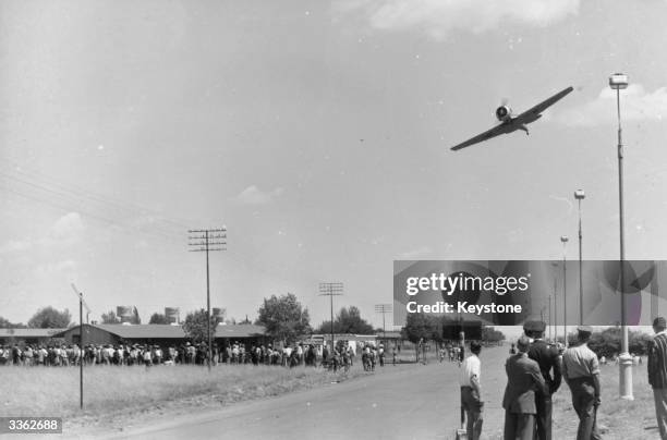 South African Airforce plane flies low over Africans at Sharpeville in an attempt to frighten villagers protesting at a rule which forces them to...