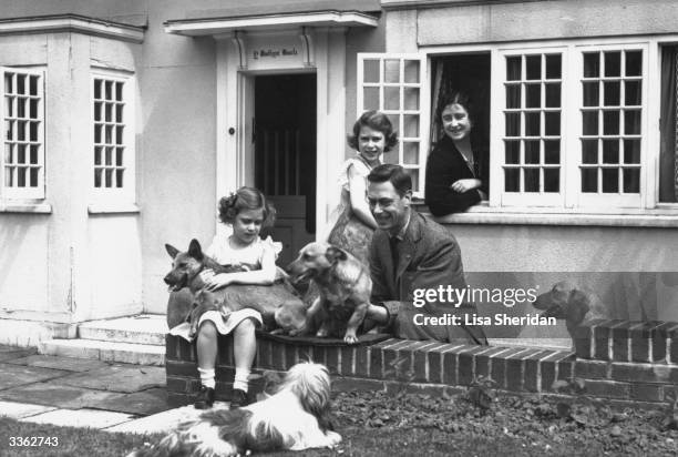 King George VI and Queen Elizabeth with Princesses Margaret Rose and Elizabeth at Y Bwthyn Bach , a miniature cottage in the grounds of Windsor...