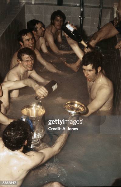 Members of Chelsea Football Club celebrate with champagne in the bath after their 2-1 victory over Leeds United in the FA Cup final replay at Old...