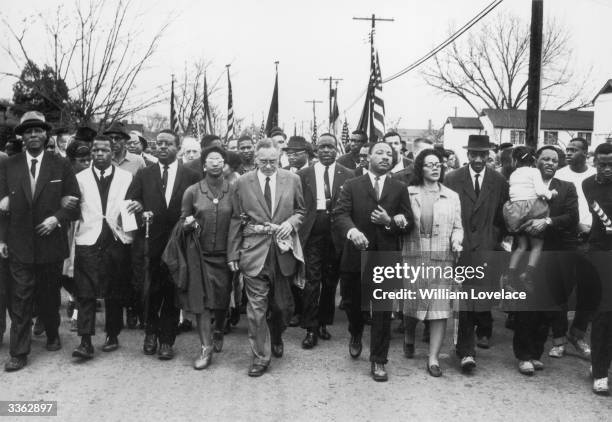 American civil rights campaigner Martin Luther King and his wife Coretta Scott King lead a black voting rights march from Selma, Alabama, to the...